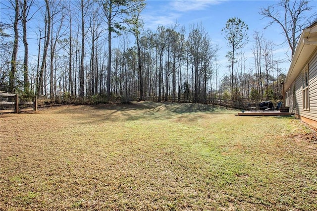 view of yard with a deck and fence