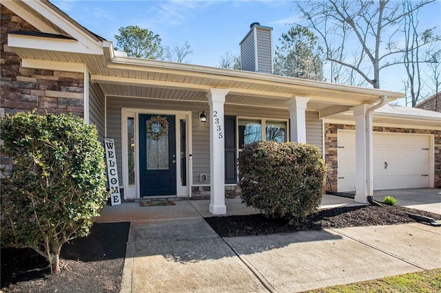 property entrance featuring a garage, stone siding, driveway, and a chimney