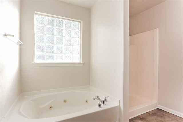 bathroom with tile patterned flooring and independent shower and bath