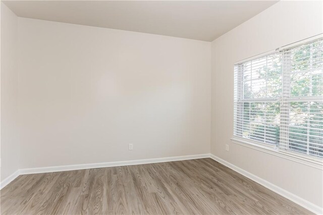 unfurnished room with light hardwood / wood-style flooring