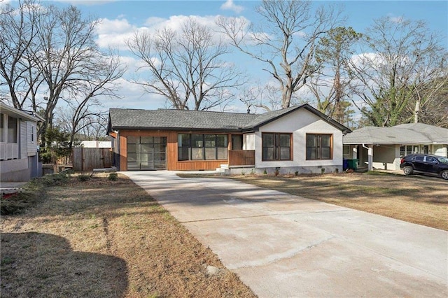 view of front of house with driveway, crawl space, fence, and a front lawn