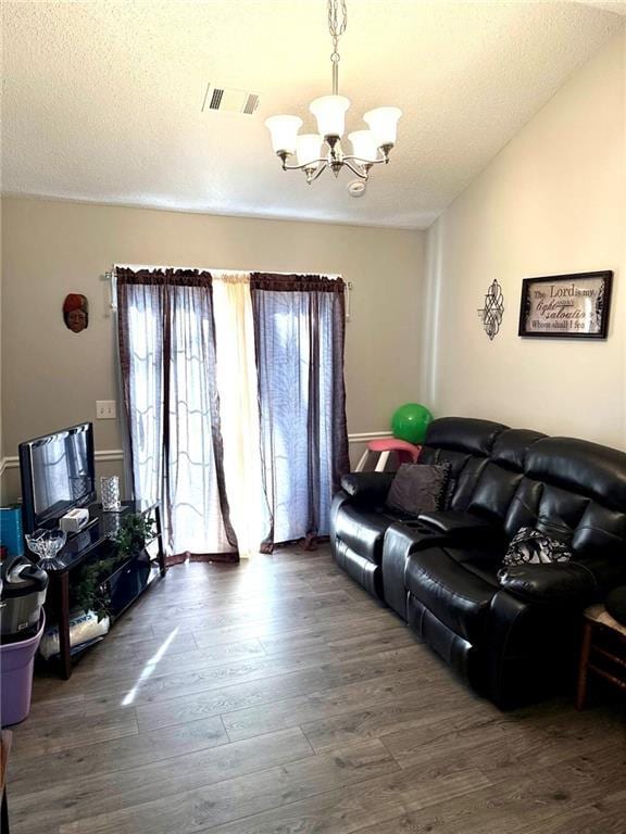 6030 Creekside Dr, Columbus, GA 31907 - living area with visible vents, wood finished floors, and a notable chandelier