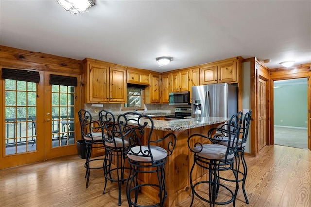 442 Cartecay River Run, Ellijay, GA 30536 - kitchen featuring appliances with stainless steel finishes, light wood-style flooring, plenty of natural light, and a kitchen breakfast bar