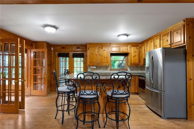442 Cartecay River Run, Ellijay, GA 30536 - kitchen with appliances with stainless steel finishes, light wood-style floors, french doors, a kitchen bar, and tasteful backsplash