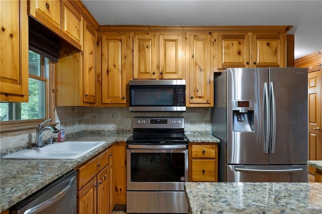 442 Cartecay River Run, Ellijay, GA 30536 - kitchen featuring stainless steel appliances, a sink, tasteful backsplash, brown cabinetry, and light stone countertops