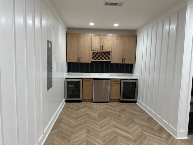 kitchen with wine cooler, visible vents, refrigerator, and light countertops