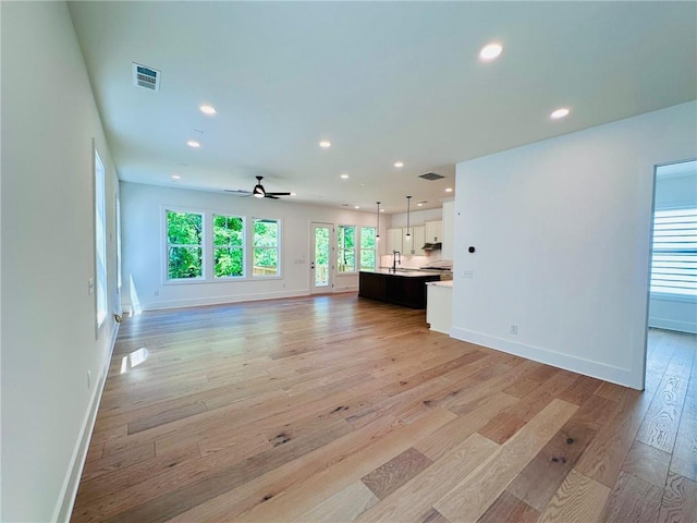 unfurnished living room with ceiling fan, visible vents, light wood-style flooring, and recessed lighting