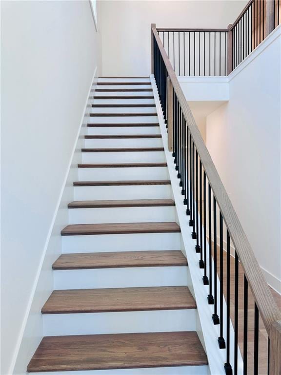 stairway featuring a high ceiling