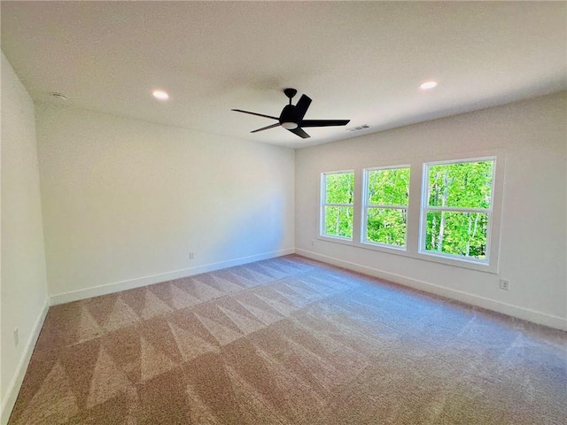 empty room featuring recessed lighting, carpet, and baseboards