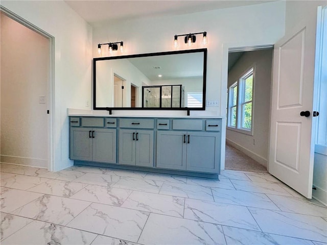 full bath featuring marble finish floor, vanity, and baseboards