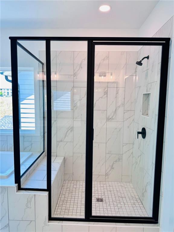 full bathroom with recessed lighting and a stall shower