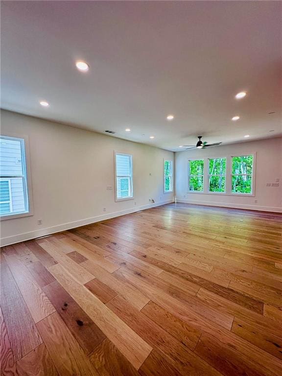 spare room featuring recessed lighting, baseboards, ceiling fan, and light wood finished floors