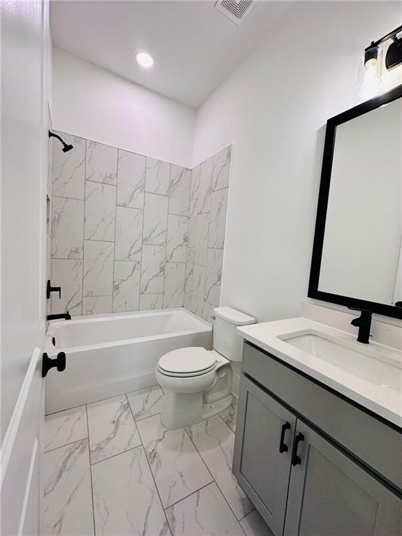 full bath featuring visible vents, toilet, shower / tub combination, marble finish floor, and vanity