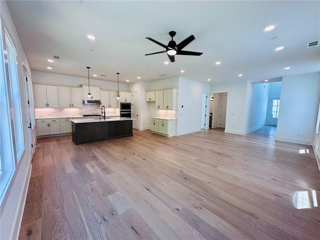 kitchen featuring recessed lighting, light wood-type flooring, and open floor plan