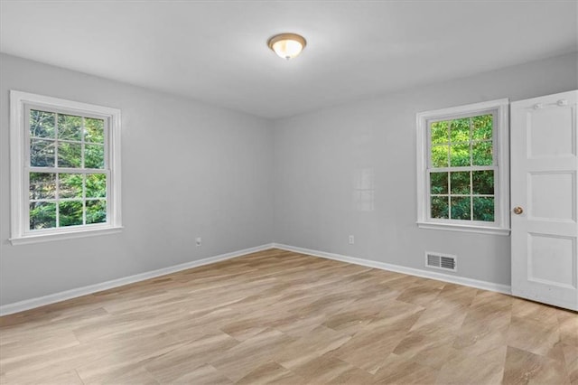 empty room with visible vents and baseboards