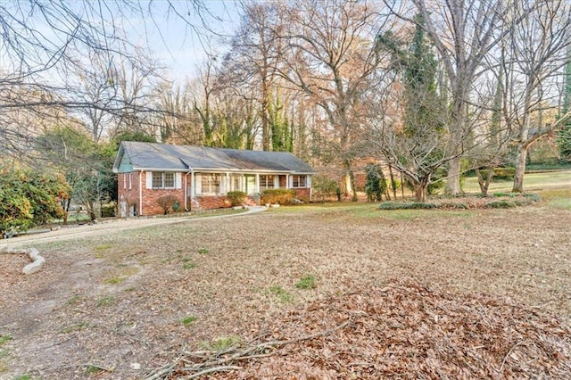 single story home featuring brick siding