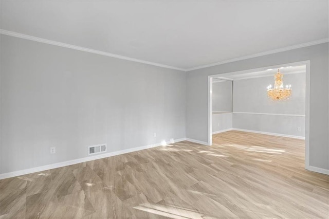 empty room featuring baseboards, crown molding, visible vents, and a notable chandelier