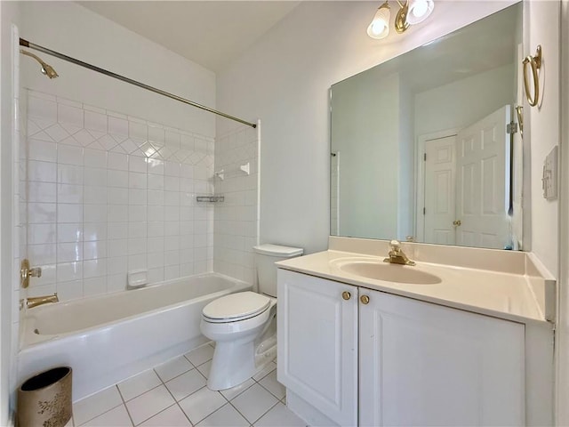 full bathroom with tiled shower / bath, tile patterned floors, toilet, and vanity