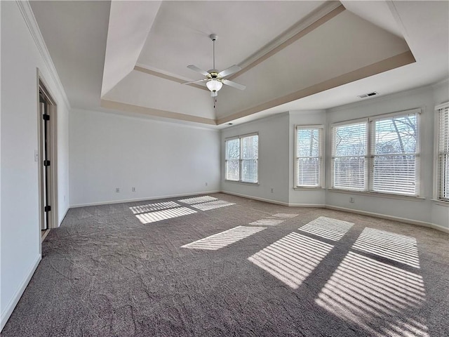 carpeted empty room featuring crown molding, ceiling fan, and a tray ceiling