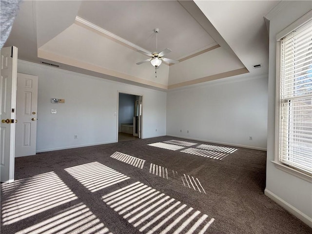 carpeted empty room featuring crown molding, a raised ceiling, and ceiling fan