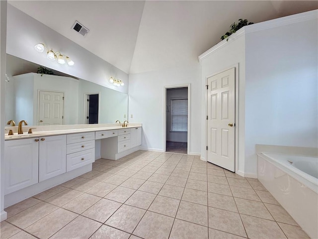 bathroom featuring vanity, lofted ceiling, tile patterned floors, and a bathtub