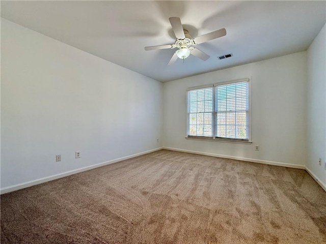 empty room featuring ceiling fan and carpet floors