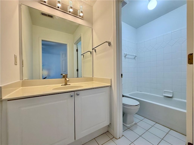 full bathroom featuring vanity, tiled shower / bath, tile patterned floors, and toilet