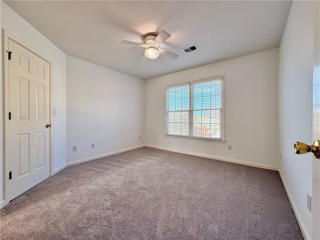 spare room with ceiling fan and carpet flooring