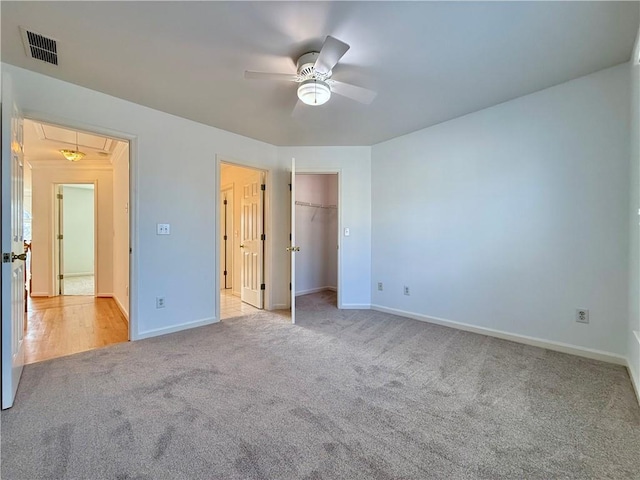 unfurnished bedroom with light colored carpet and ceiling fan