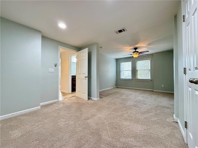 interior space featuring ceiling fan and light carpet