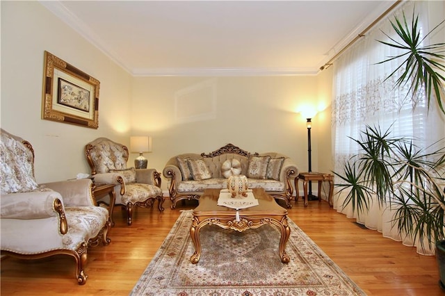 living room with ornamental molding and light hardwood / wood-style floors