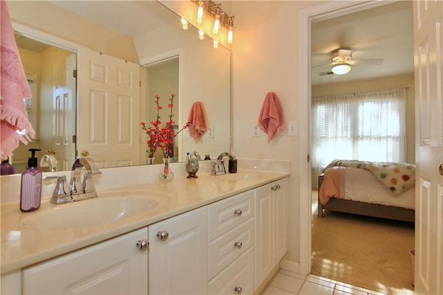 bathroom with tile patterned flooring, vanity, and ceiling fan