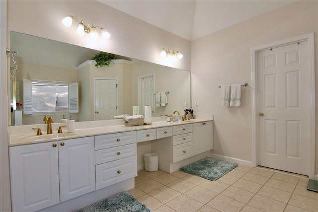 bathroom with tile patterned flooring, vanity, and vaulted ceiling