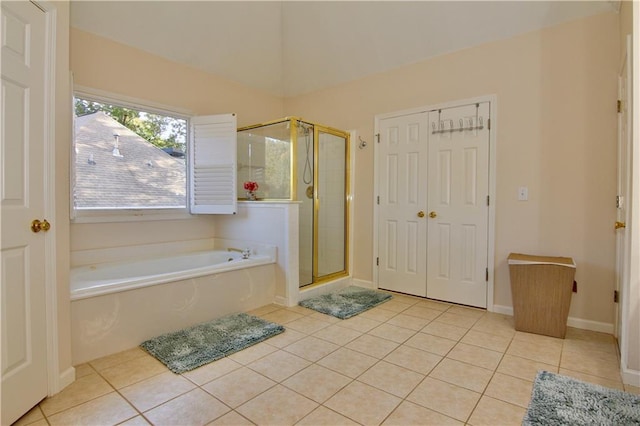 bathroom with separate shower and tub and tile patterned flooring