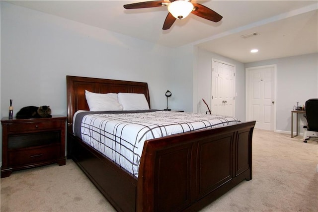 bedroom with ceiling fan and light carpet