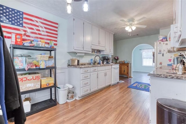 1015 Carriage Way, Loganville, GA 30052 - kitchen with white appliances, arched walkways, a ceiling fan, white cabinets, and a textured ceiling