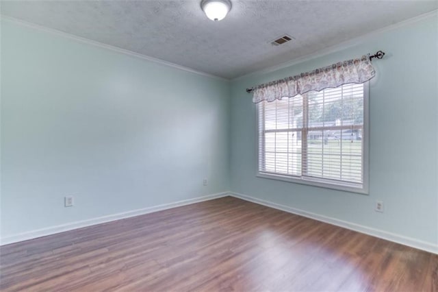 1015 Carriage Way, Loganville, GA 30052 - unfurnished room featuring wood finished floors, a textured ceiling, baseboards, and crown molding