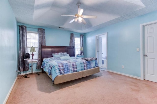 1015 Carriage Way, Loganville, GA 30052 - carpeted bedroom with a raised ceiling, multiple windows, baseboards, and a textured ceiling