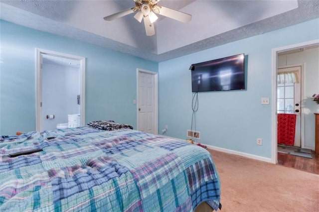 1015 Carriage Way, Loganville, GA 30052 - carpeted bedroom with baseboards, a ceiling fan, and ensuite bath