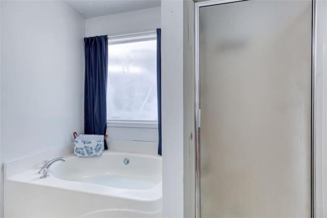 1015 Carriage Way, Loganville, GA 30052 - bathroom with a shower stall and a bath