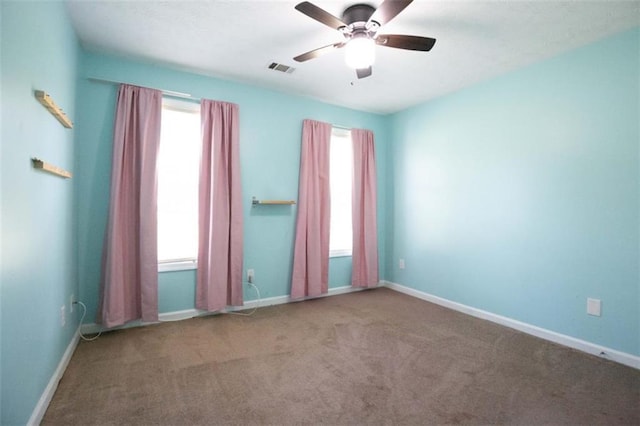 1015 Carriage Way, Loganville, GA 30052 - carpeted spare room featuring a ceiling fan and baseboards