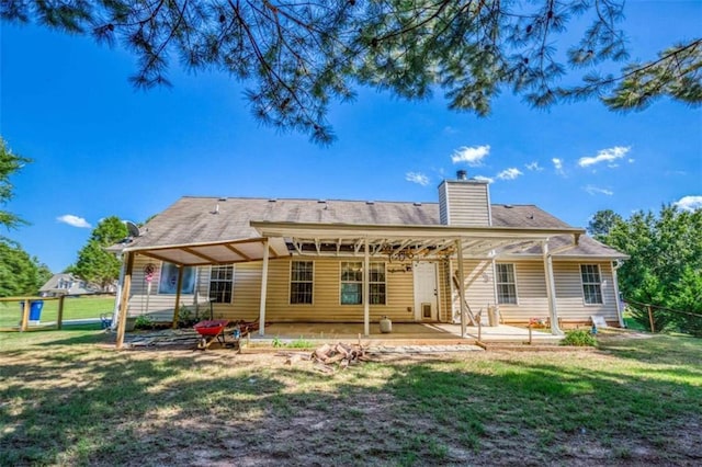 1015 Carriage Way, Loganville, GA 30052 - rear view of property featuring a patio area and a chimney