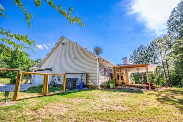 1015 Carriage Way, Loganville, GA 30052 - rear view of house with a chimney, central AC, and a gate