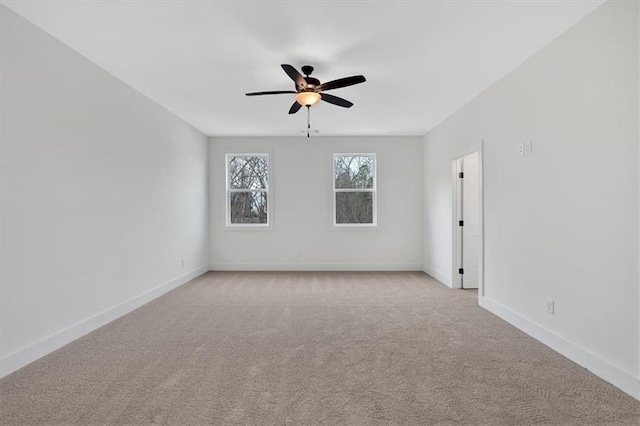 empty room featuring light carpet, ceiling fan, and baseboards