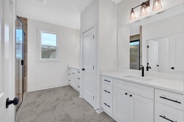 bathroom with marble finish floor, a shower stall, baseboards, and vanity