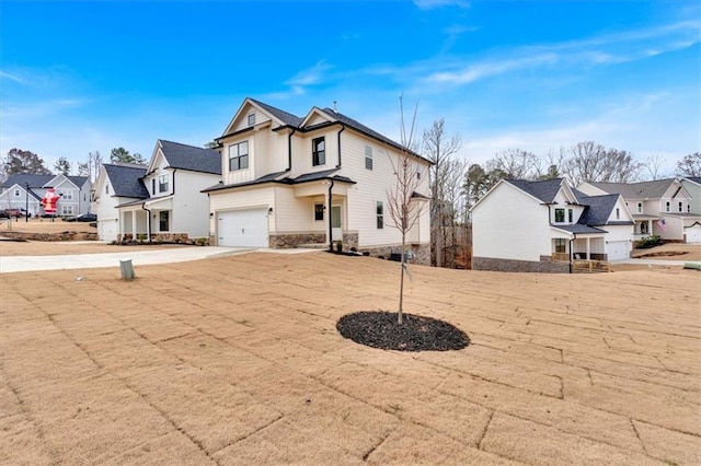 view of front facade featuring a garage, a residential view, and driveway