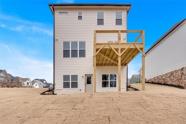 back of house with a wooden deck