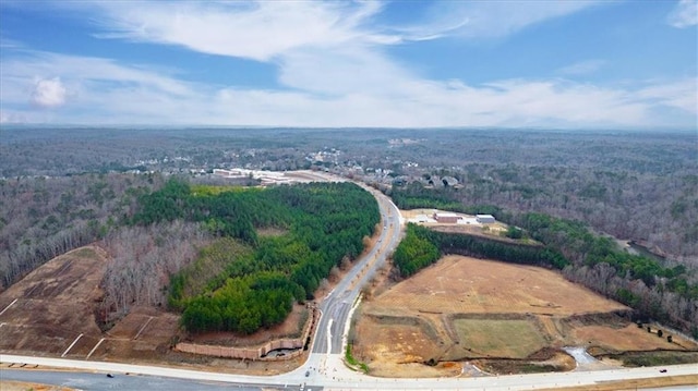 drone / aerial view with a wooded view