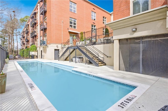 pool featuring a patio and stairway