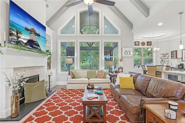 living room with a high end fireplace, beam ceiling, dark hardwood / wood-style floors, and ceiling fan